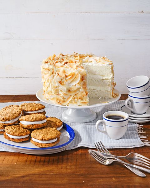 coconut angel cake on a stand with a cup of coffee near by