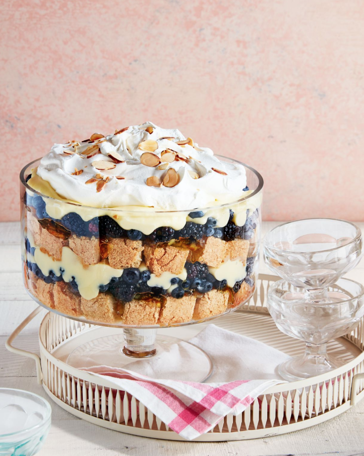 fruit and nut trifle in a glass trifle dish with serving cups to the side
