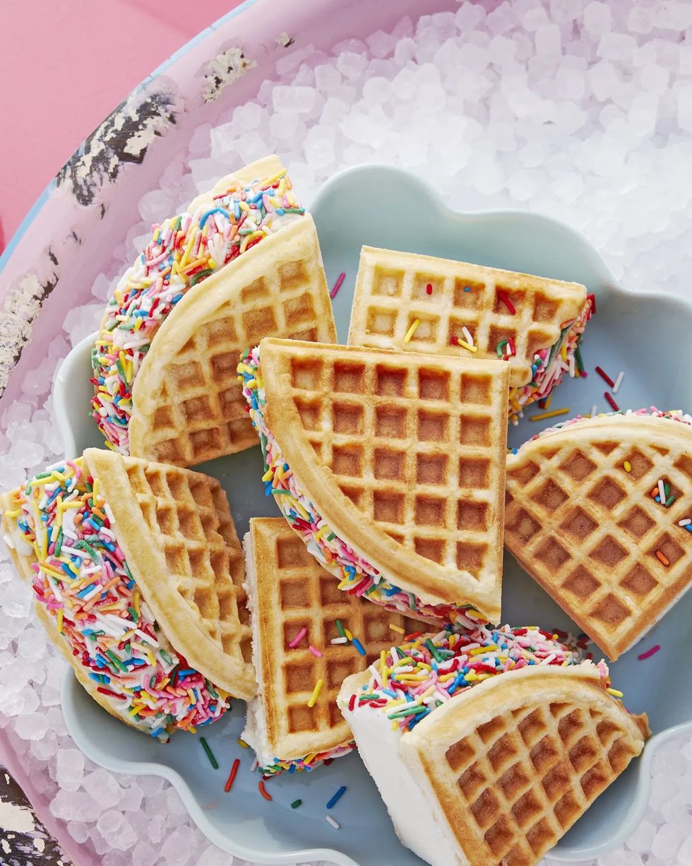 rainbow waffle sandwiches arranged in a pie dish in a bowl of ice to keep them cold