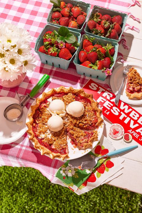 strawberry almond crumble pie on a picnic table with a strawberry festival bumper sticker