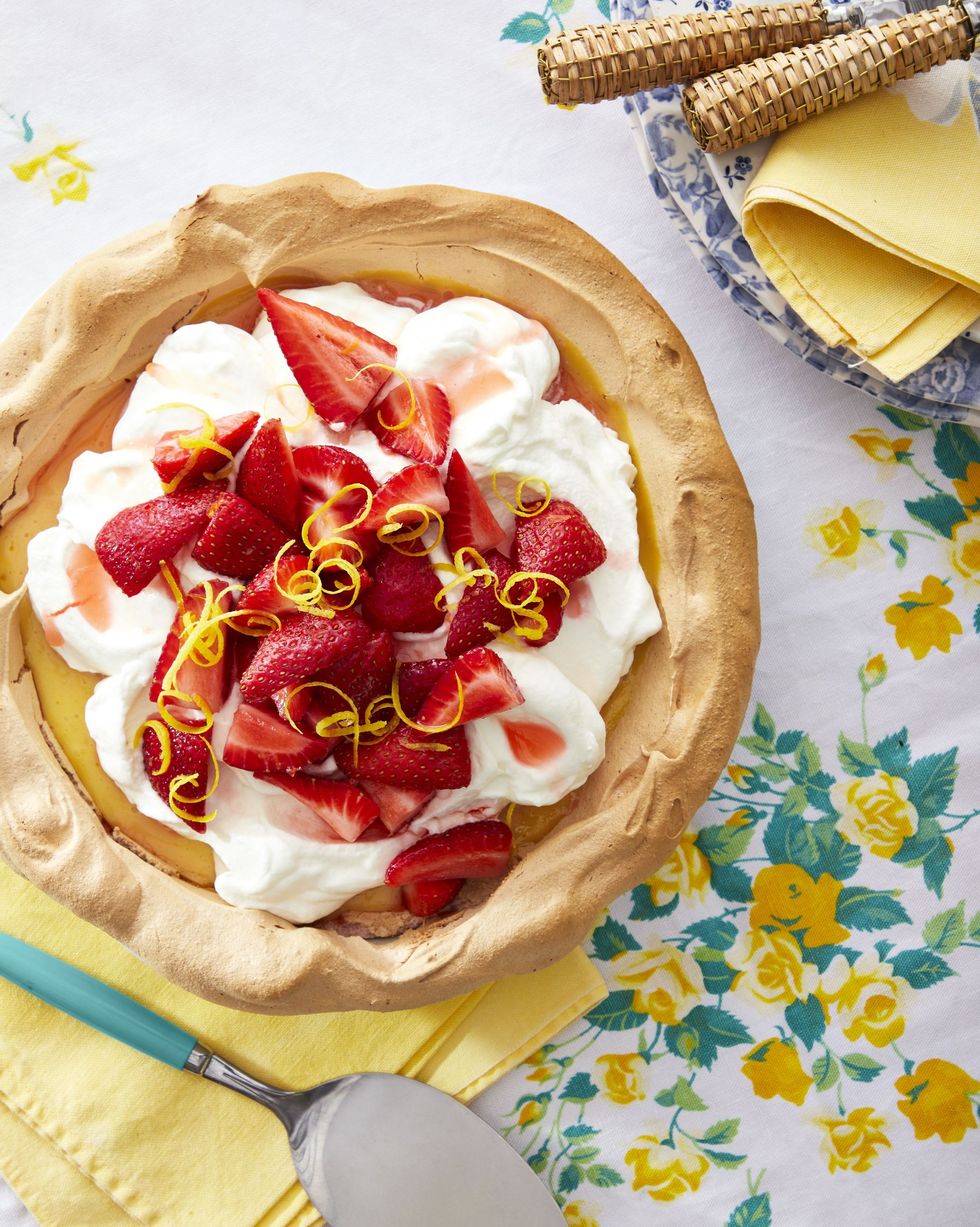 strawberry lemonade angel pie in a meringue crust and topped with whipped cream fresh strawberries and lemon zest