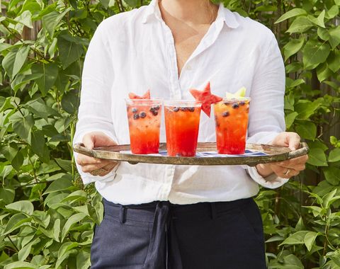 strawberry lemonade punch on a tray with star shaped melon garnishes for fourth of july