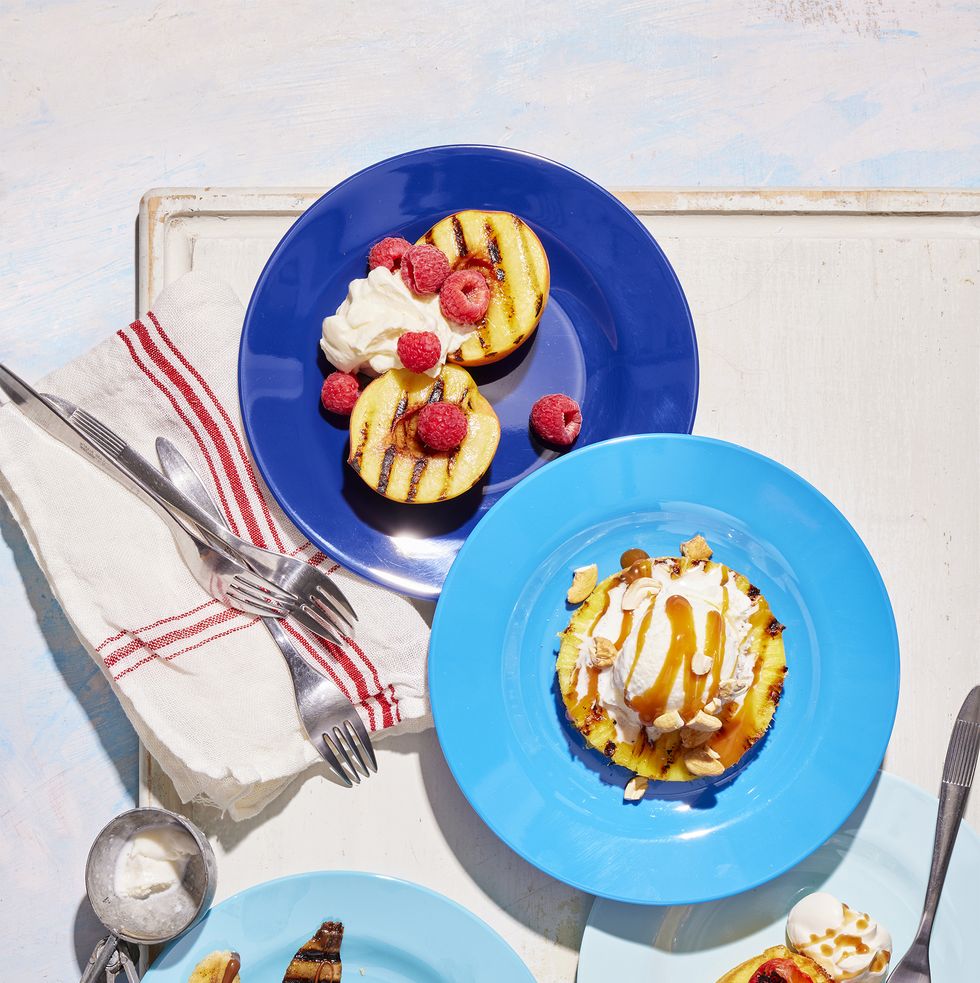 grilled fruit desserts and ice cream served on blue plates in various shades