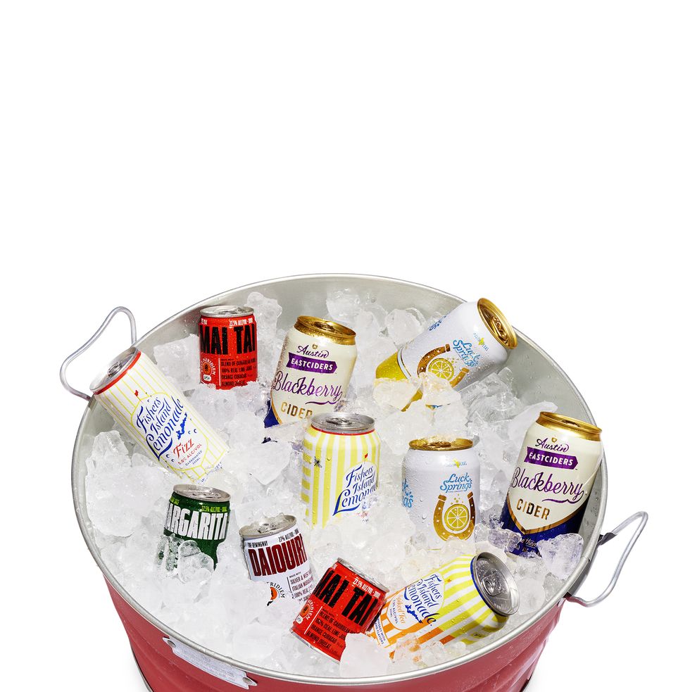 a red tub filled with ice and a variety of canned drinks