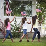 4th of july quotes three girls holding mini american flags and walking through their front yard