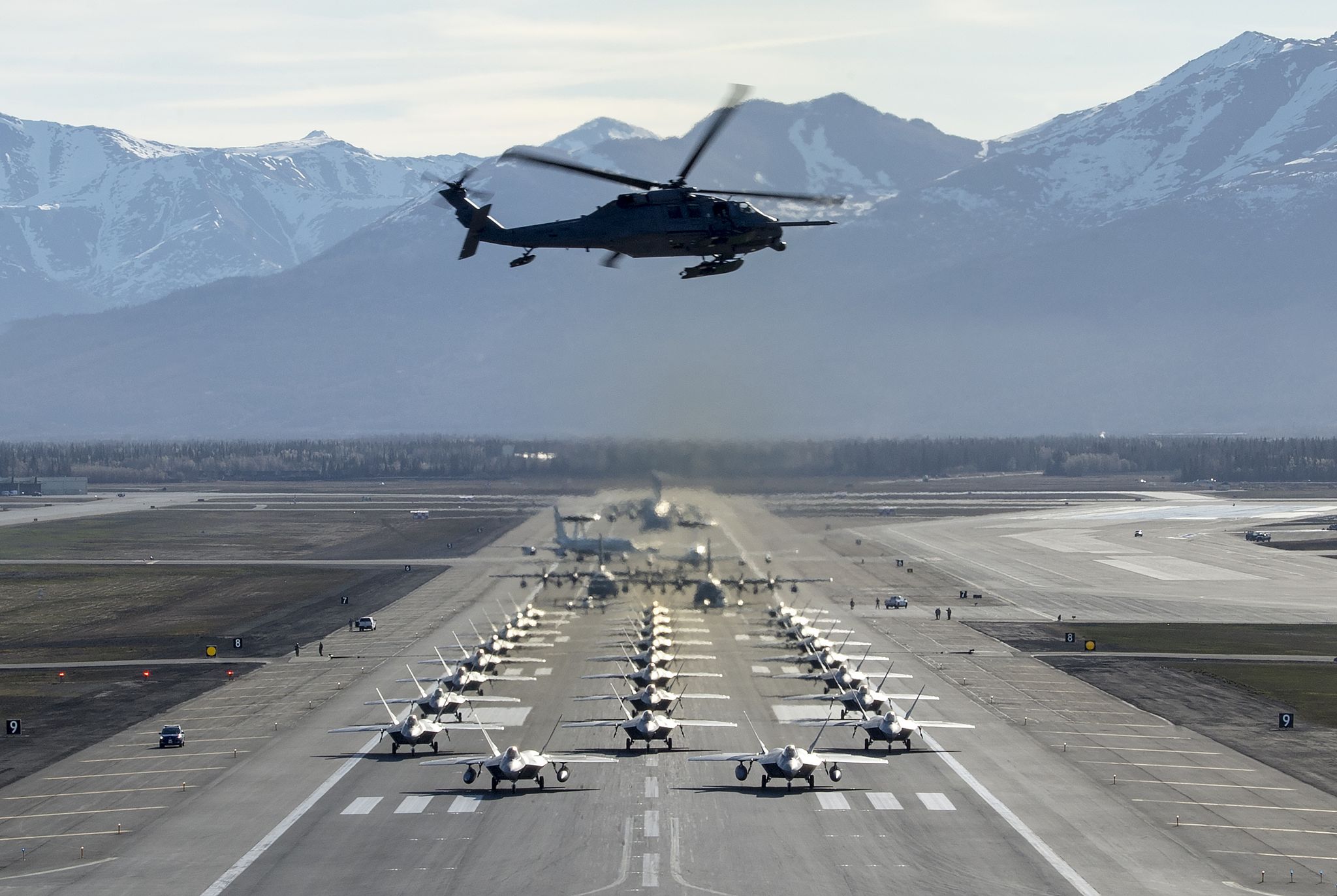 an alaska air national guard hh 60g pave hawk flies over a close formation taxi known as an elephant walk at joint base elmendorf richardson, alaska, may 5, 2020 the large show of force demonstrated the wings’ rapid mobility capabilities and response readiness during covid 19 and also highlighted the ability to generate combat airpower at a moment’s notice to ensure regional stability throughout the north american aerospace defense command region and indo pacific us air force photo by senior airman jonathan valdes montijo