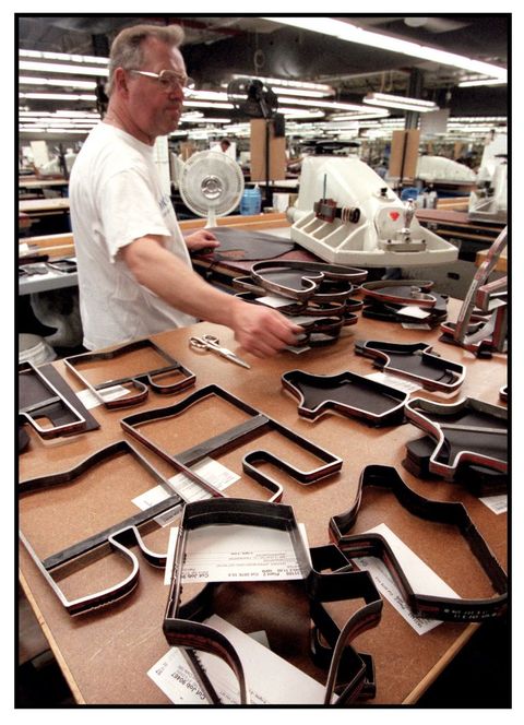 a leather cutter at red wing, bill dankern, with an array of his cutting patterns in 2001﻿