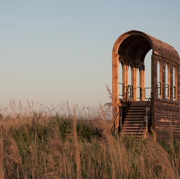 a building with pillars in a field