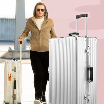 a person standing next to a suitcase
