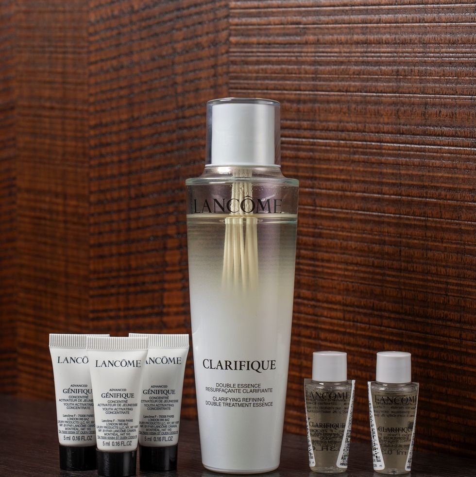 a bottle of perfume and several glasses