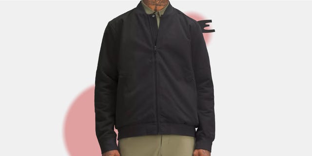 black bomber jacket worn over a lightcolored shirt