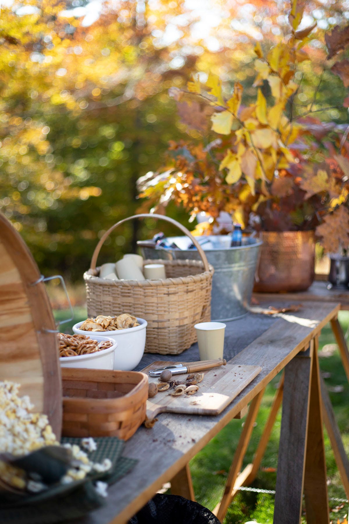 an outdoor buffet with nuts, popcorn, and pretzels