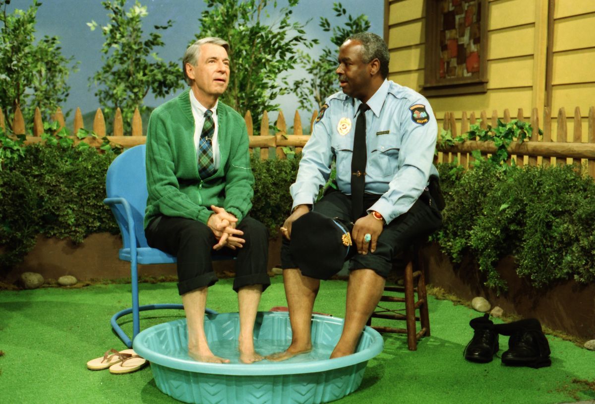 Mister Rogers and Officer Clemmons soaking their feet in a wading pool