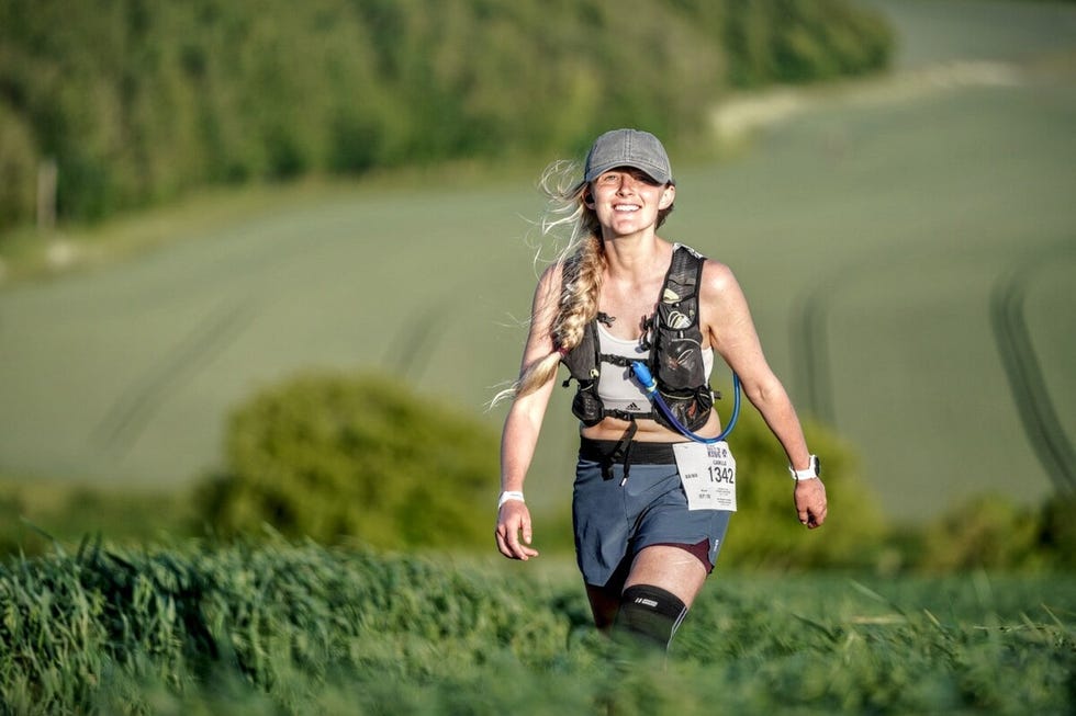 smiling woman in the countryside during a trail ultramarathon