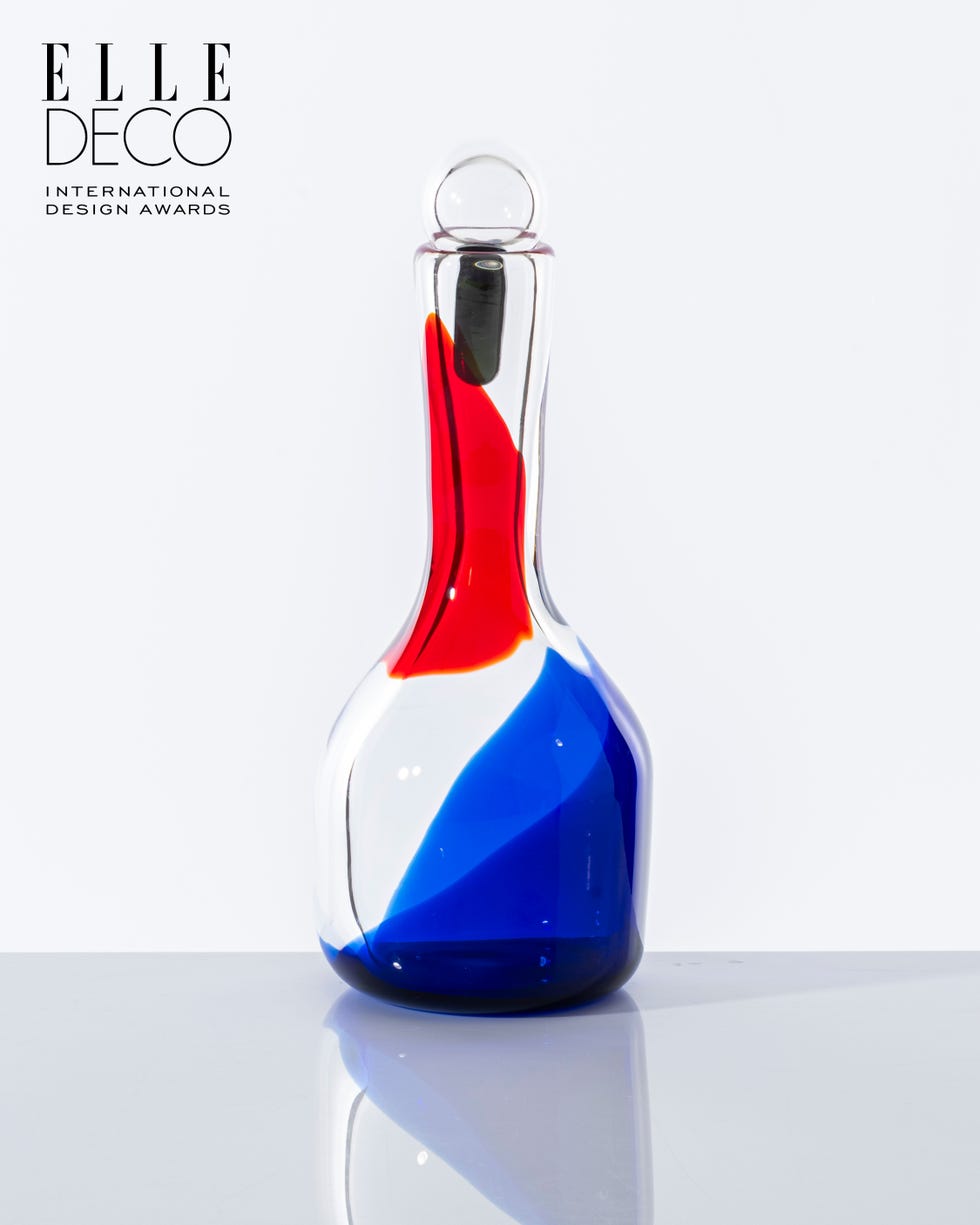 Colorful glass decanter with red, blue, and clear sections.