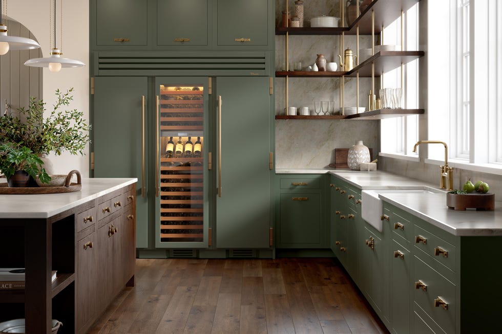 Modern kitchen featuring green cabinetry and wine refrigerator.