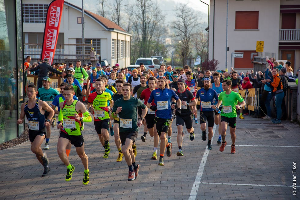 a group of people running on a street