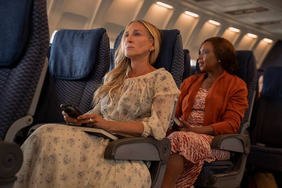 Passengers seated in an airplane cabin.