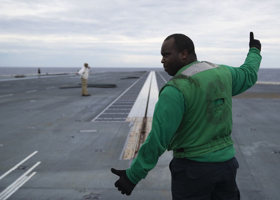 atlantic ocean nov 15, 2019 aviation boatswain's mate equipment 2nd class d'shawn armstrong, from jersey city, new jersey, assigned to uss gerald r ford's cvn 78 air department, signals the electromagnetic aircraft launch system emals to launch during no load testing on the ship's flight deck this was the first test of ford's emals since the end of its post shakedown availability us navy photo by mass communication specialist 3rd class zachary melvin