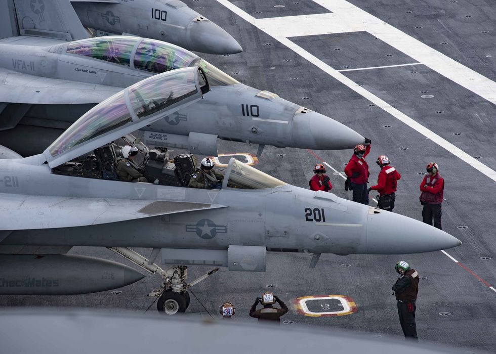 191121 n ut641 0006 atlantic ocean nov 21, 2019 pilots assigned to the “fighting checkmates” of strike fighter squadron 211 prepare to exit the cockpit of an fa 18f super hornet on the flight deck of the nimitz class aircraft carrier uss harry s truman cvn 75 truman is underway conducting operations at sea to reintegrate the carrier strike group and make final preparations to ensure the carrier, air wing, and sailors are operationally ready to deploy us navy photo by mass communication specialist seaman apprentice janiel adamesreleased
