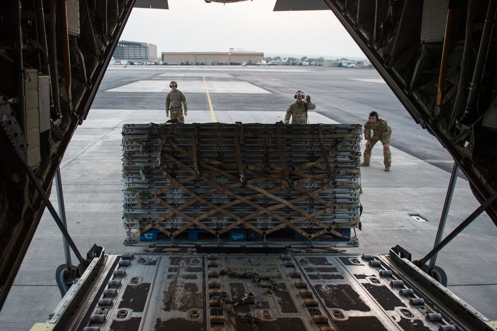 members assigned to the 75th expeditionary airlift squadron, watch as cargo slides down the ramp of a c 130j super hercules sept 5, 2019, in east africa  the 75th eas supports cjtf hoa with medical evacuations, disaster relief, humanitarian and air drop operations us air force photo by senior airman sean carnes