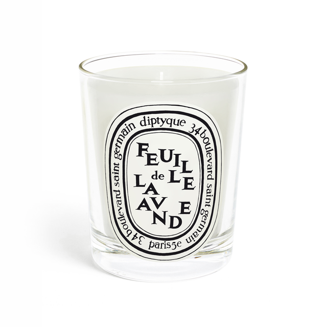 Lavender-scented candle in a glass container with a decorative label.