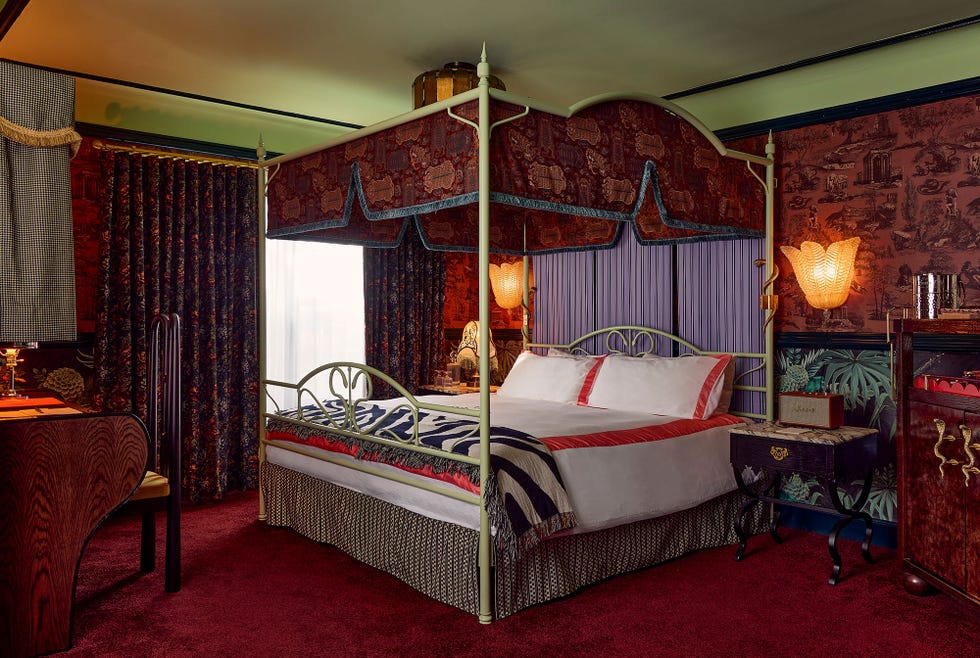 Stylish bedroom with a four-poster bed and decorative elements.