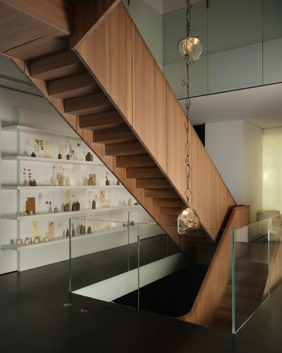 Wooden staircase leads to an upper level with a modern design.