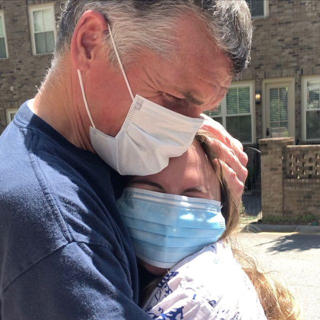 eliza paris and her father hug in medical face masks