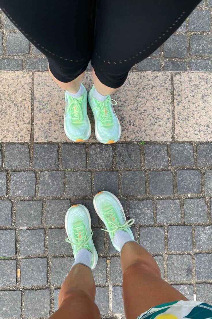 a pair of feet with green shoes