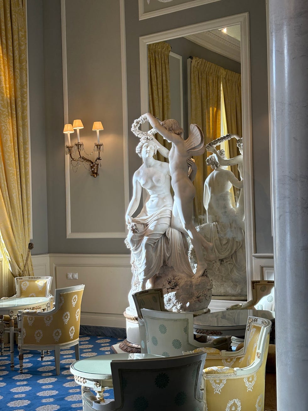 Sculpture of a classical scene set in an elegant room.