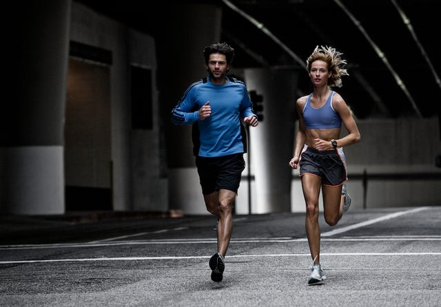 a man and a woman running on a track