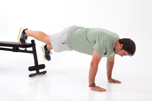 a man doing a back bend on a trampoline