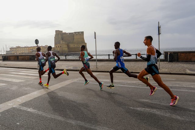 a group of people running on a road