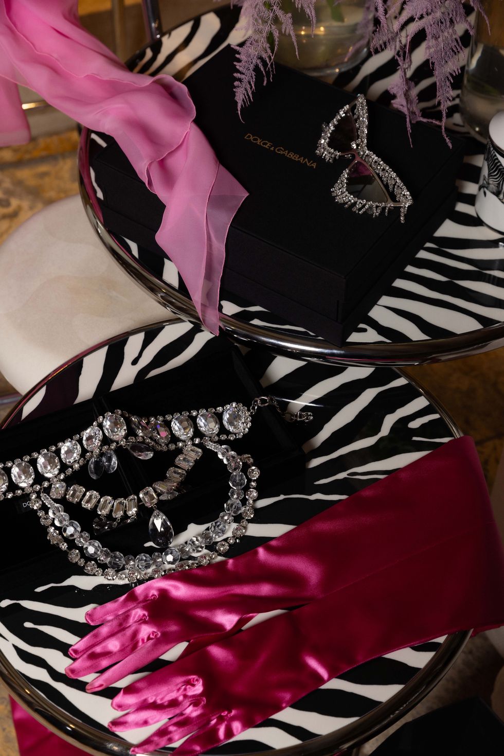 a collection of pink gloves and jewelry