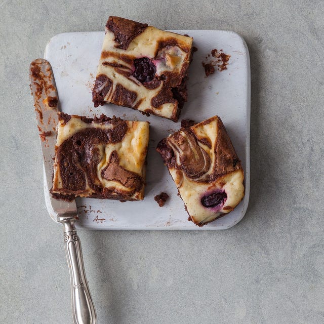 marble cheesecake brownies with a serving knife on a cutting board