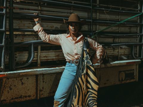 cowgirl posing with tiger print chaps