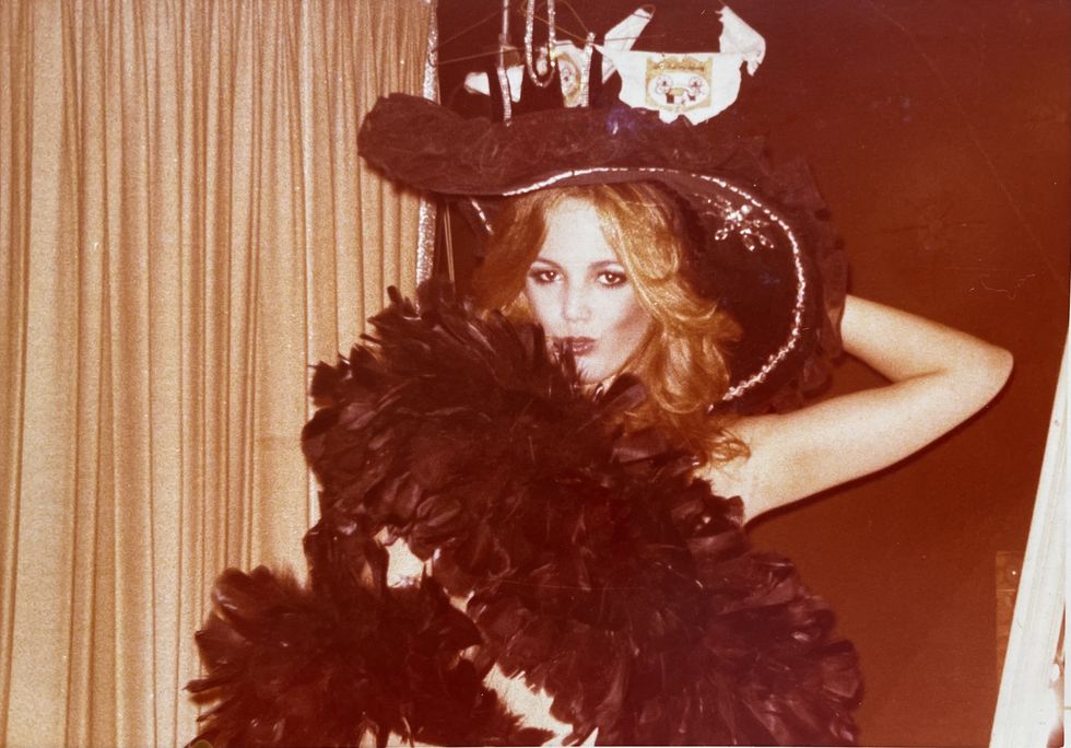 minka kelly's mother maureen dumont kelly posing for a glamor shot in a feather boa in her early 20s