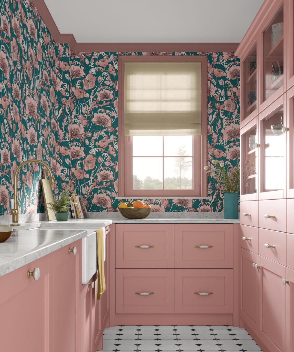 Pink and blue floral wallpaper in a pink Shaker kitchen with black and white floor