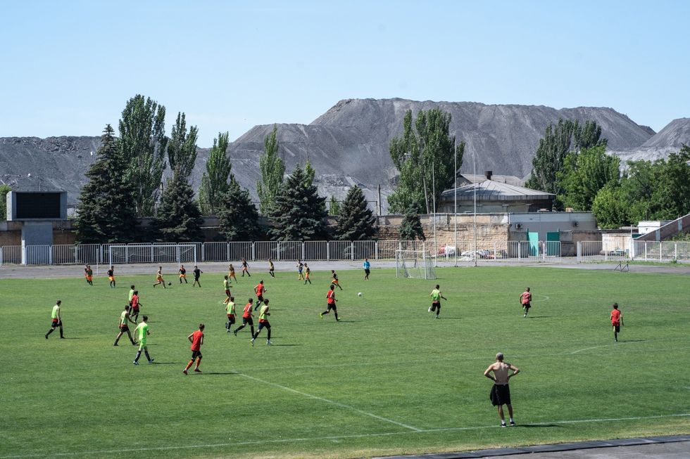 Het voetbalteam van Azovstal traint in de buurt van de stortplaats van de fabriek De fabriek helpt tientallen kinderen om te kunnen sporten