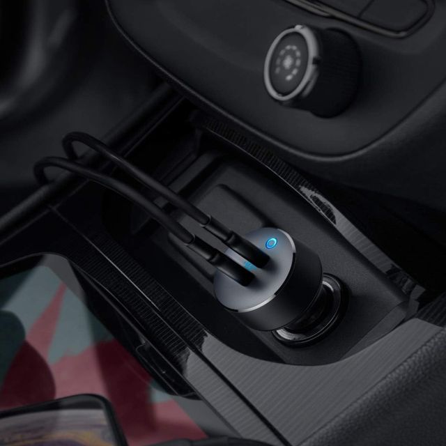 anker car charger plugged into a dashboard with two cables