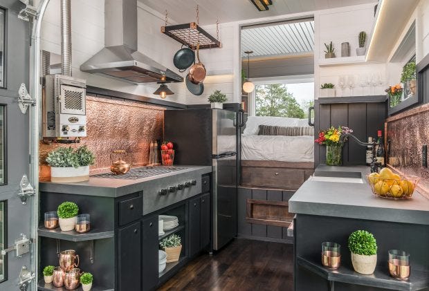 a kitchen with a stove and shelves