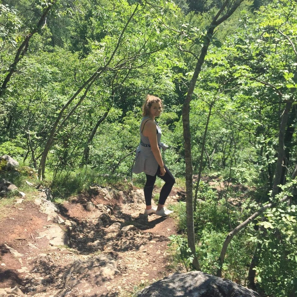 sofia fenton on a walk along the towpath under trees.
