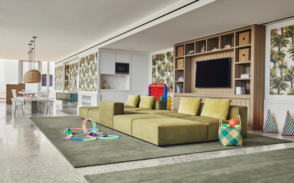 Spacious living area with plush sofa and children's play area