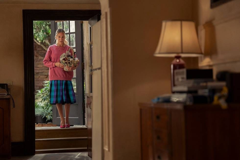 A person standing at the door holding a basket.