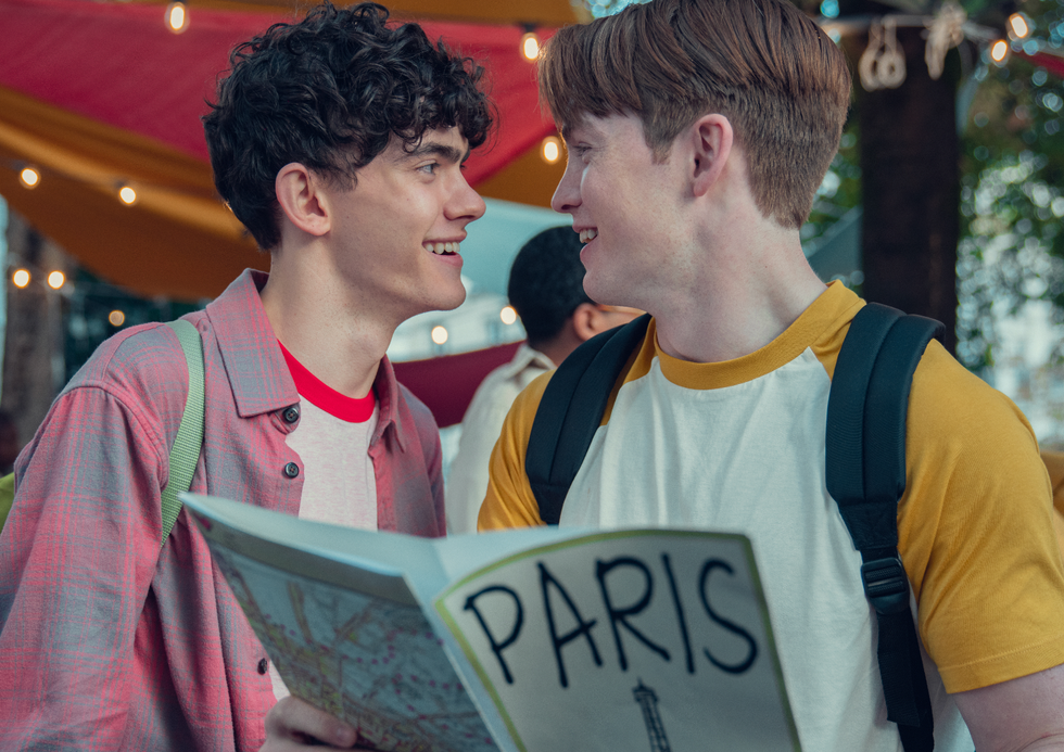 Male couple holding a sign Heartstopper Season 2 Paris