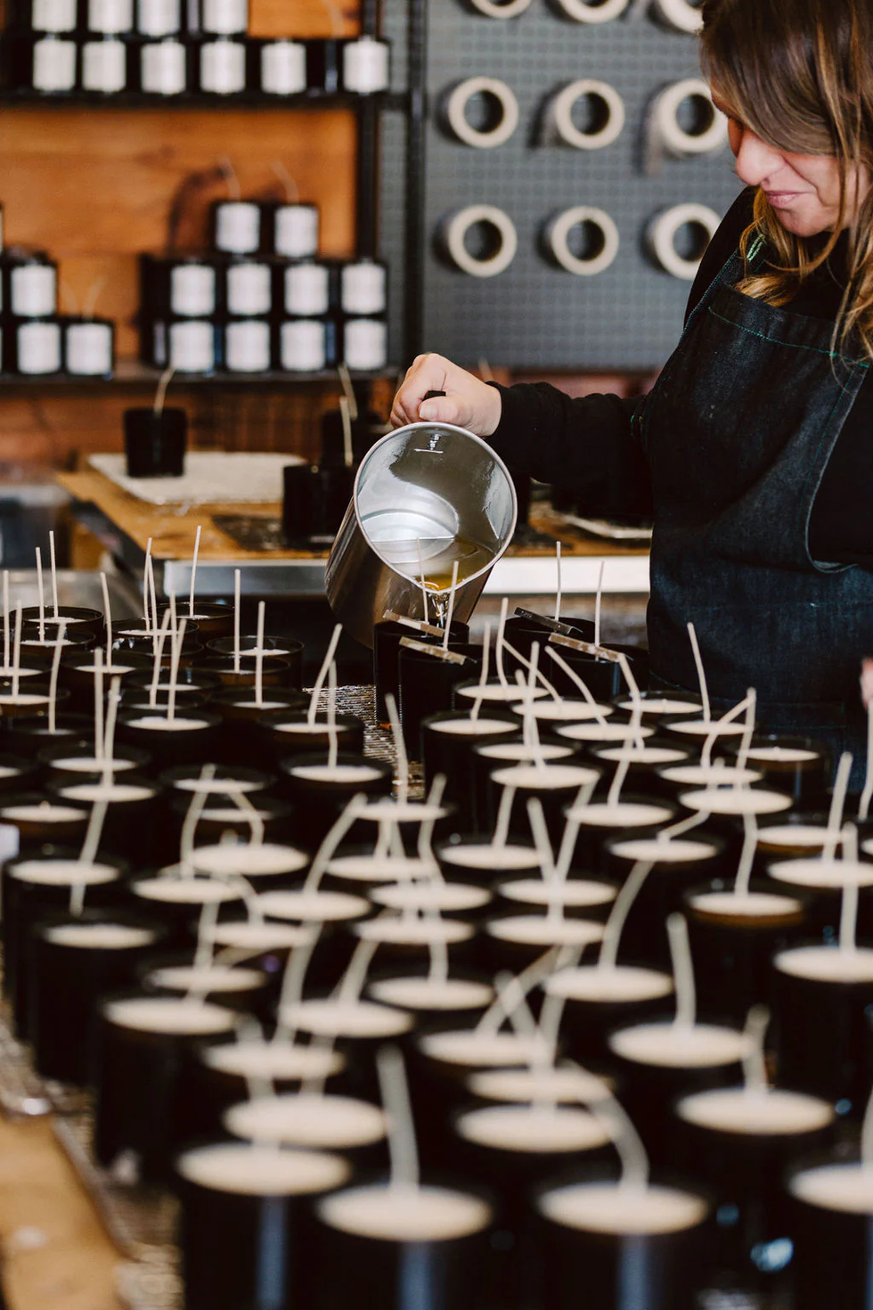 Candle making process, pouring wax into containers.