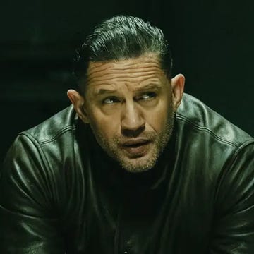 figure seated in a dark environment wearing a black leather jacket figure seated in a dark environment wearing a black leather jacket