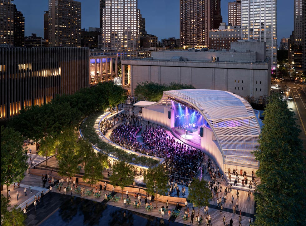 Outdoor concert scene in a park with a large crowd.