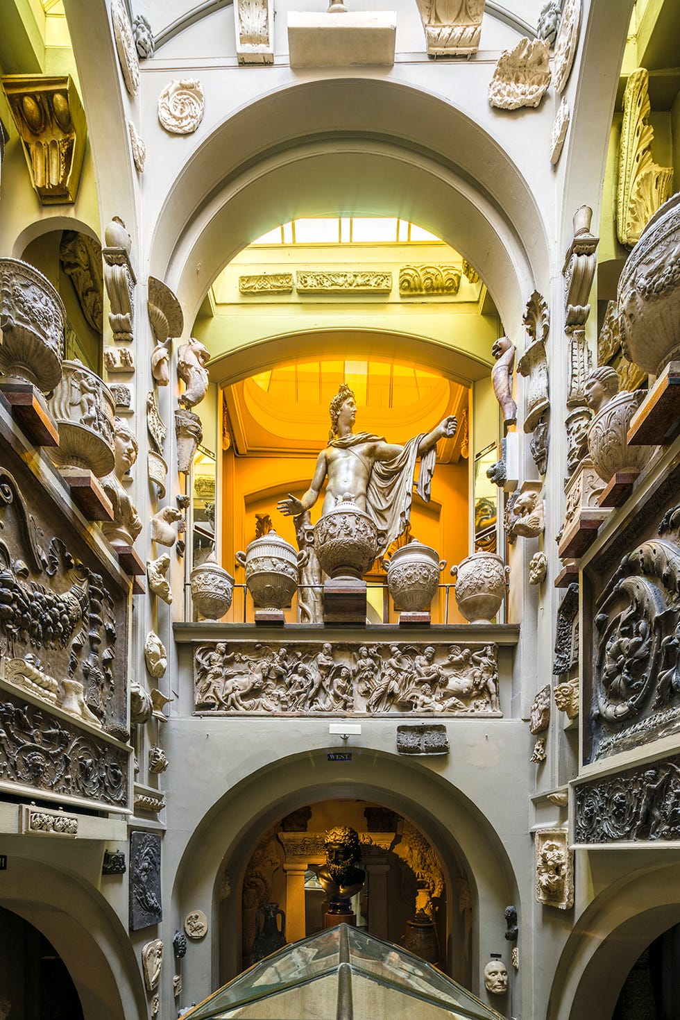 Historical museum interior featuring classical sculptures and ornate decorations.
